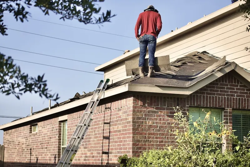 Professional roofer working on a residential roof in Griswold